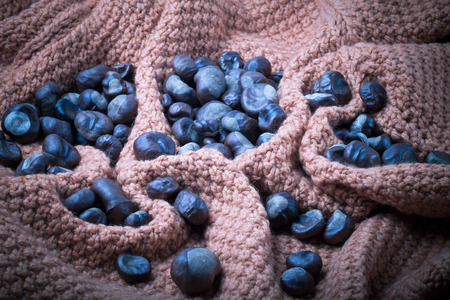 Many chestnuts on a knitted orange background. Toned gray.の写真素材