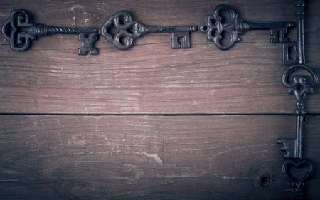 Vintage keys on old wooden boards. Frame or background. Space for text. Toned.の写真素材