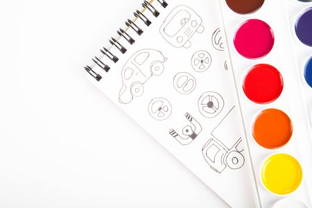 Watercolors and drawings graphically against a white sheet of paper.の写真素材