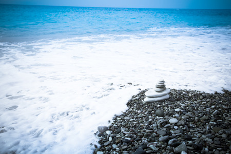 The pyramid of pebbles on the beach.の写真素材