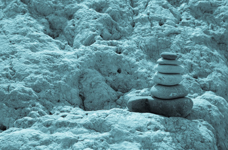 concept of balance and harmony. stacked stones pyramid on a marble rock.の写真素材