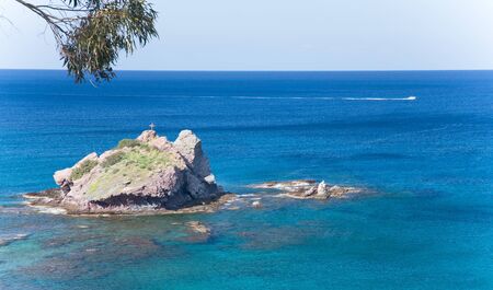 Trees hanging over the beautiful colored sea. Polis, Cyprus.の写真素材