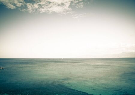 Beautiful colored sea. On the horizon are visible sailboat and motorboat. Polis, Cyprus.の写真素材