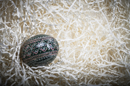 Painted easter egg in paper straw.の写真素材
