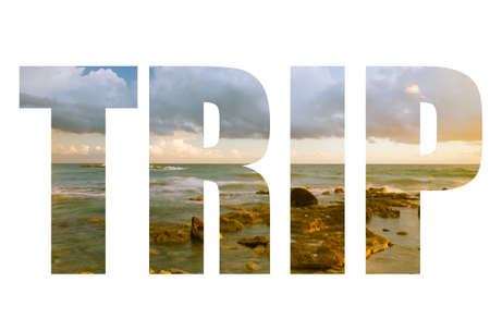 Word TRIP over Seascape  with low clouds above the stony shore of the sea.
