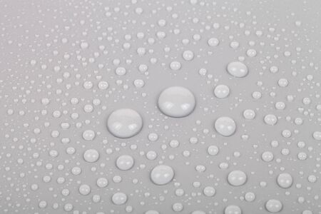 Drops of water on a color background. Gray. Shallow depth of field. Selective focus.の写真素材