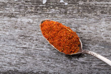 Antique metal spoon with saffron on an old wooden table. Selective focus.の写真素材
