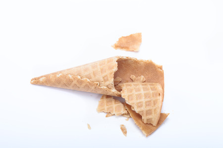 Crashed cone for ice cream isolated on a light background.の写真素材