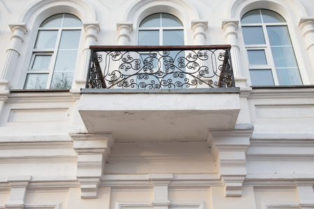 Wrought-iron balcon on the light side of the building.の写真素材