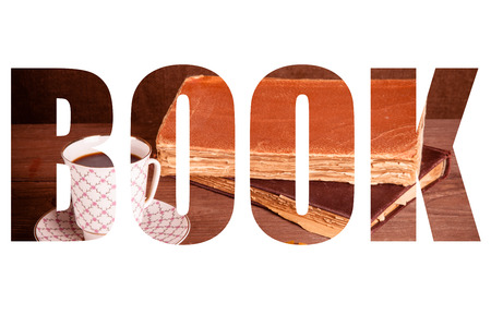 Title book on a white background. cup of coffee, jam and old books on a wooden table.の写真素材