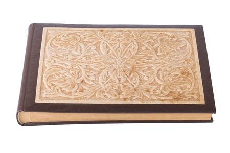 Old photo album with carved cover isolated on white background.