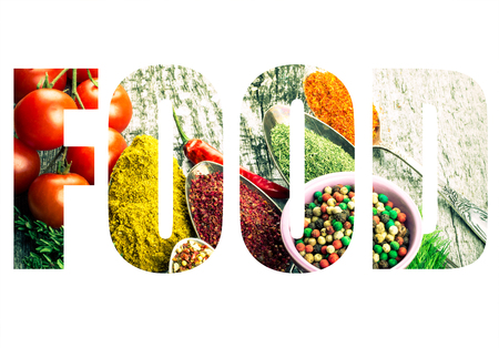 Word FOOD over Bunch of cherry tomatoes, herbs, small bowl and antic metal spoons with different kinds of spices, sea salt and red hot chili peppers on old wooden board. Selective focus. Toned.の写真素材