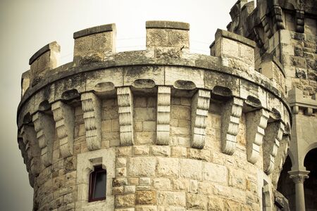 The round stone tower of the castle on the promenade in the town of Estoril. Portugal. Toned.のeditorial素材