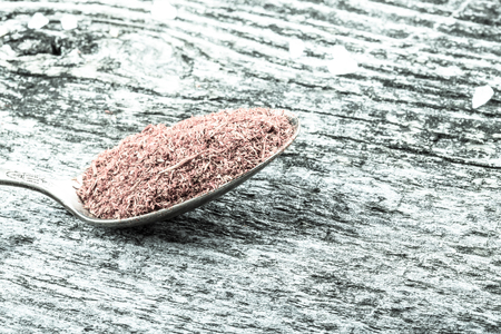 Antic metal spoons with salvia on old wooden board. Selective focus. Toned.の写真素材
