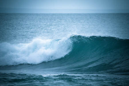 The emerging wave of the sea near the coast. Tintedの写真素材