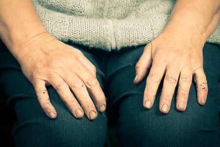Hands of an old woman lying on her lapの写真素材