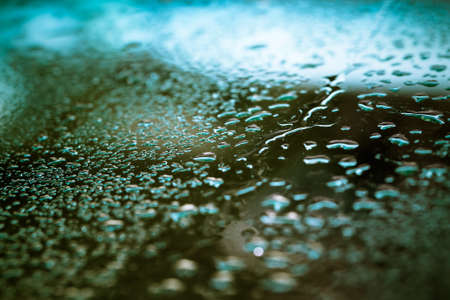 Drops of water on a color background. Shallow depth of field. Selective focus. Toned.