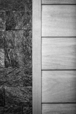Decorative wall for background - half grey stone texture and half light wood texture. Toned.