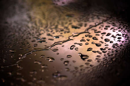 Drops of water on a color background. Shallow depth of field. Selective focus. Toned.