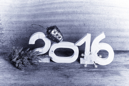 Wooden figures 2016, a branch of the Christmass tree, the plastic snowflake and old crashed...
