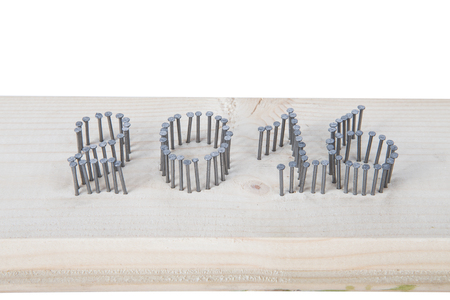 The number 2016 of nails on a light wooden background.