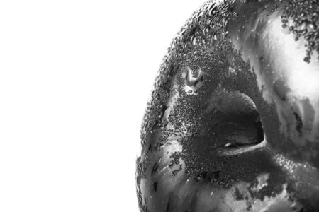 Closeup of part of fresh juicy ripe purple plum with white background like space for text. Selective focus. Toned.の写真素材