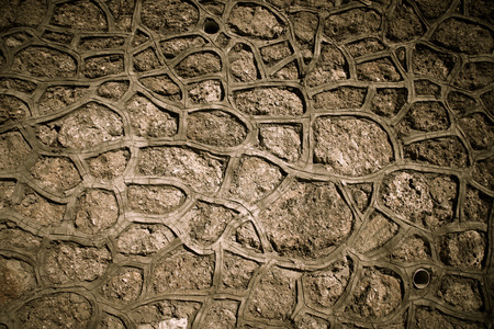 Fragment of stone texture wall or fence for natural material background. Closeup detail. Toned.