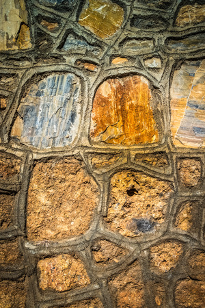 Fragment of stone texture wall or fence for natural material background. Closeup detail. Toned.の写真素材