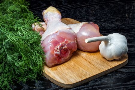 Fresh chiken legs on a black table or board like background. Toned.の写真素材