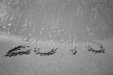 Figures 2016 sea wave with foam washes sand on the beach in Alanya Turkey. Toned.