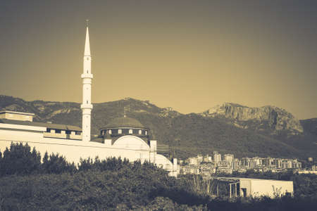 White Mosque in the green mountains in the background and a blue sky. Toned.の写真素材