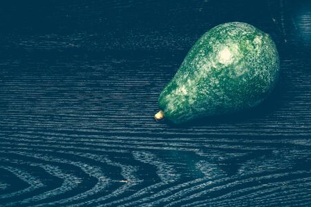 Ripe fresh avocado on a black table or board like background. Toned.