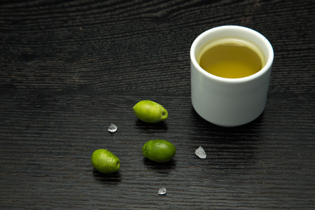 Vegetables and olive oil on a blak table. Selective focus.の写真素材