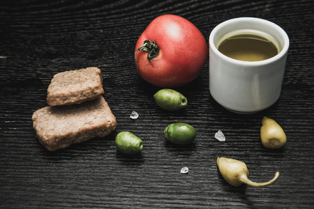 Turkish traditional meal Kofte with vegetables and olive oil on black table. Selective focus. Toned.の写真素材
