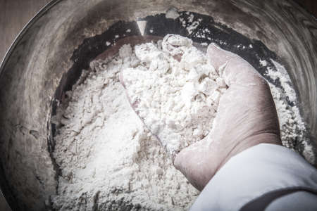 Woman's hands knead dough. Selective focus. Toned.の写真素材