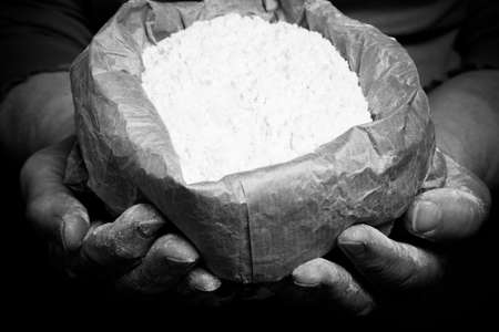 Flour in the womans hand. Selective focus. Toned.の写真素材