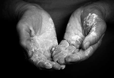 Flour in the womans hand. Selective focus. Toned.の写真素材