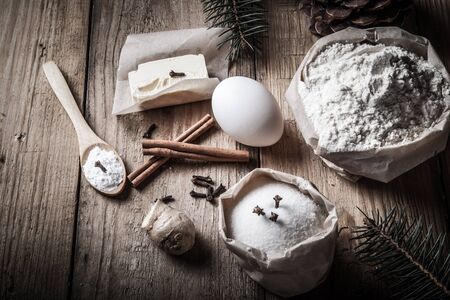 Gingerbread cookie ingredients on light wooden table or board like background. Toned.の写真素材
