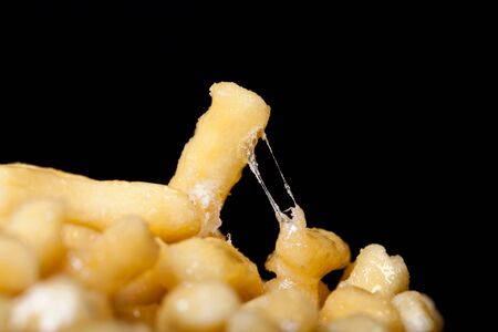 Traditional tatar sweet dessert Chak-chak with honey on a black background.