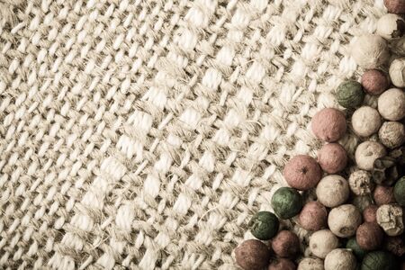 Colored pepper on a light napkin for background. Space for text. Toned.の写真素材