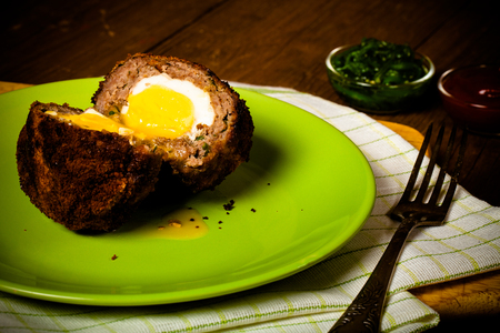 Fried cutlet  with egg inside served on a plate. Selective focus. Toned.の写真素材