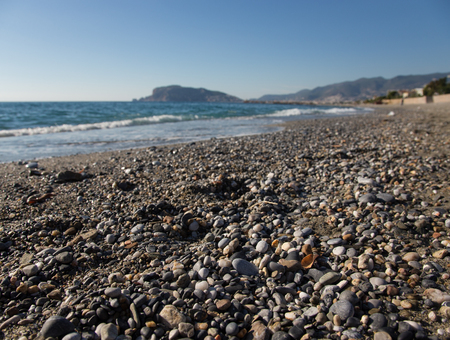 Wave on the beach and beautiful view to ancient fortress on the Alanya peninsula Turkey.の写真素材