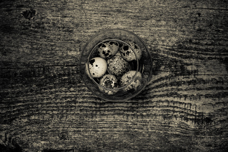Composition with quail eggs. Wooden texture for background. Toned.