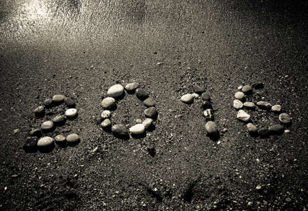 The inscription "2016" by small pebble on a wet sand seacoast. Toned.の写真素材