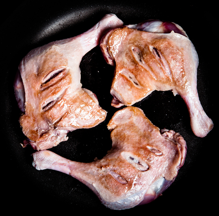 Duck legs fried in a pan. Toned.の写真素材