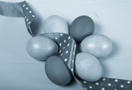 Easter eggs on blue background. Toned.の写真素材