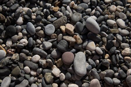 Background of natural pebble on a sea coast. Selective focus.