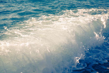 Wave on the pebble coast of sea. Selective focus. Toned.