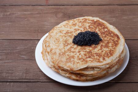 Black caviar on Russian pancakes - blini.