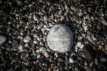 Background of natural pebble on a sea coast. Selective focus. Toned.の写真素材